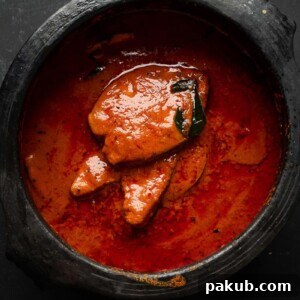Authentic spicy fish curry with coconut and tamarind, presented in the traditional mud pot it was cooked in.