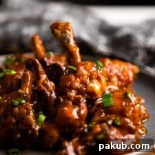 Crispy, saucy Drums of Heaven chicken lollipops served elegantly on a plate, ready to be devoured.