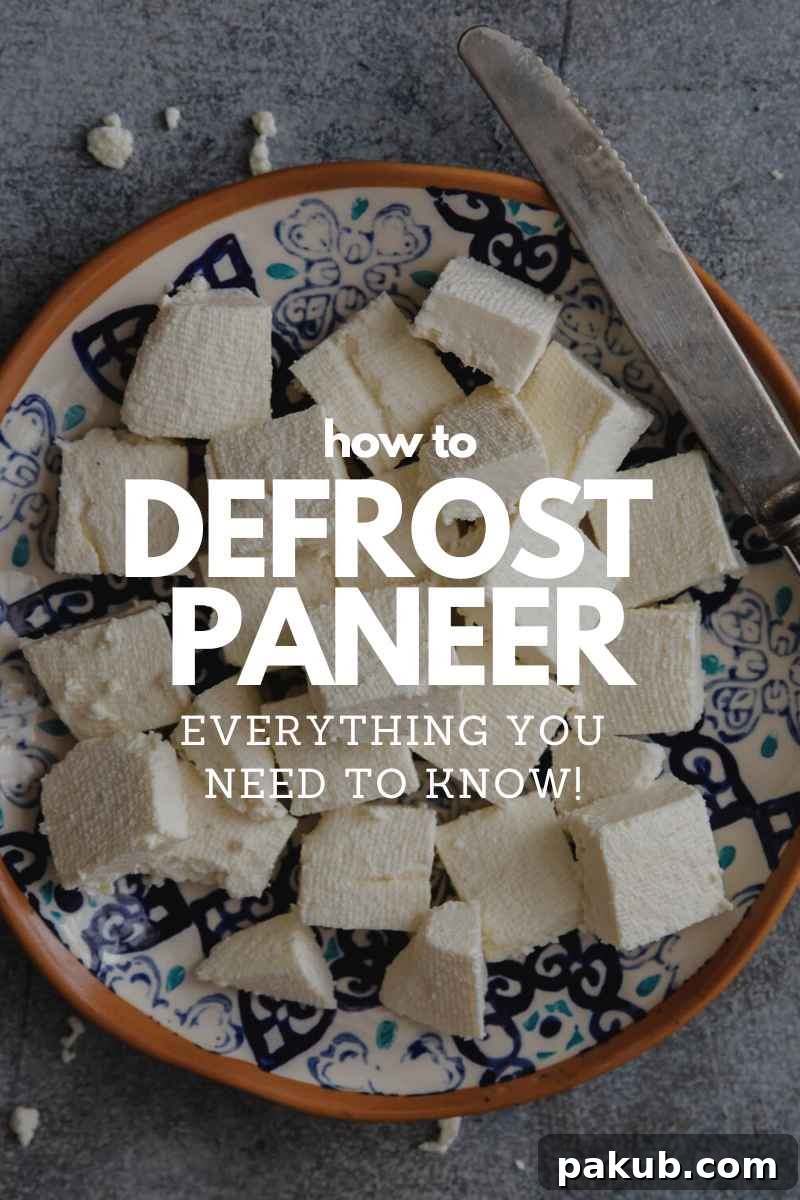 Fresh paneer cubes on a plate with a knife, ready for cooking.