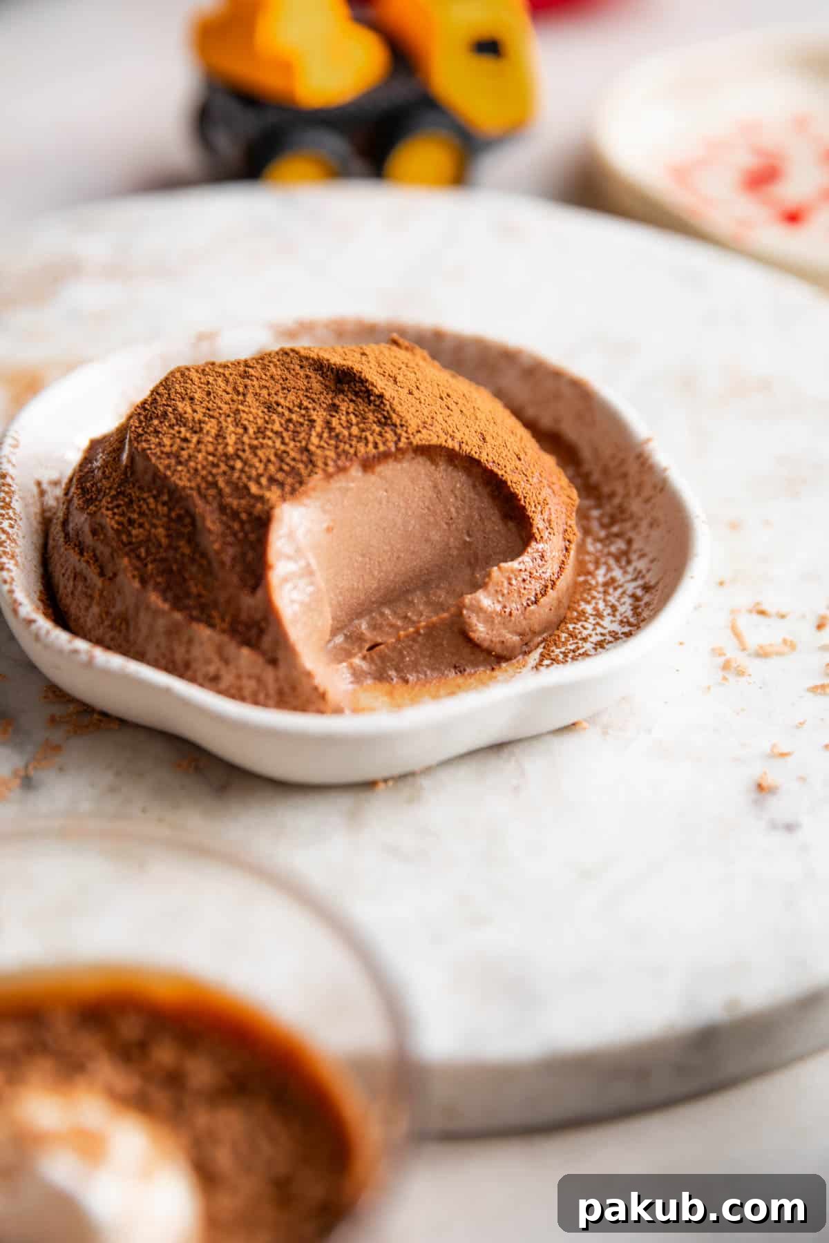 Smooth & creamy paneer chocolate pudding served on a white plate