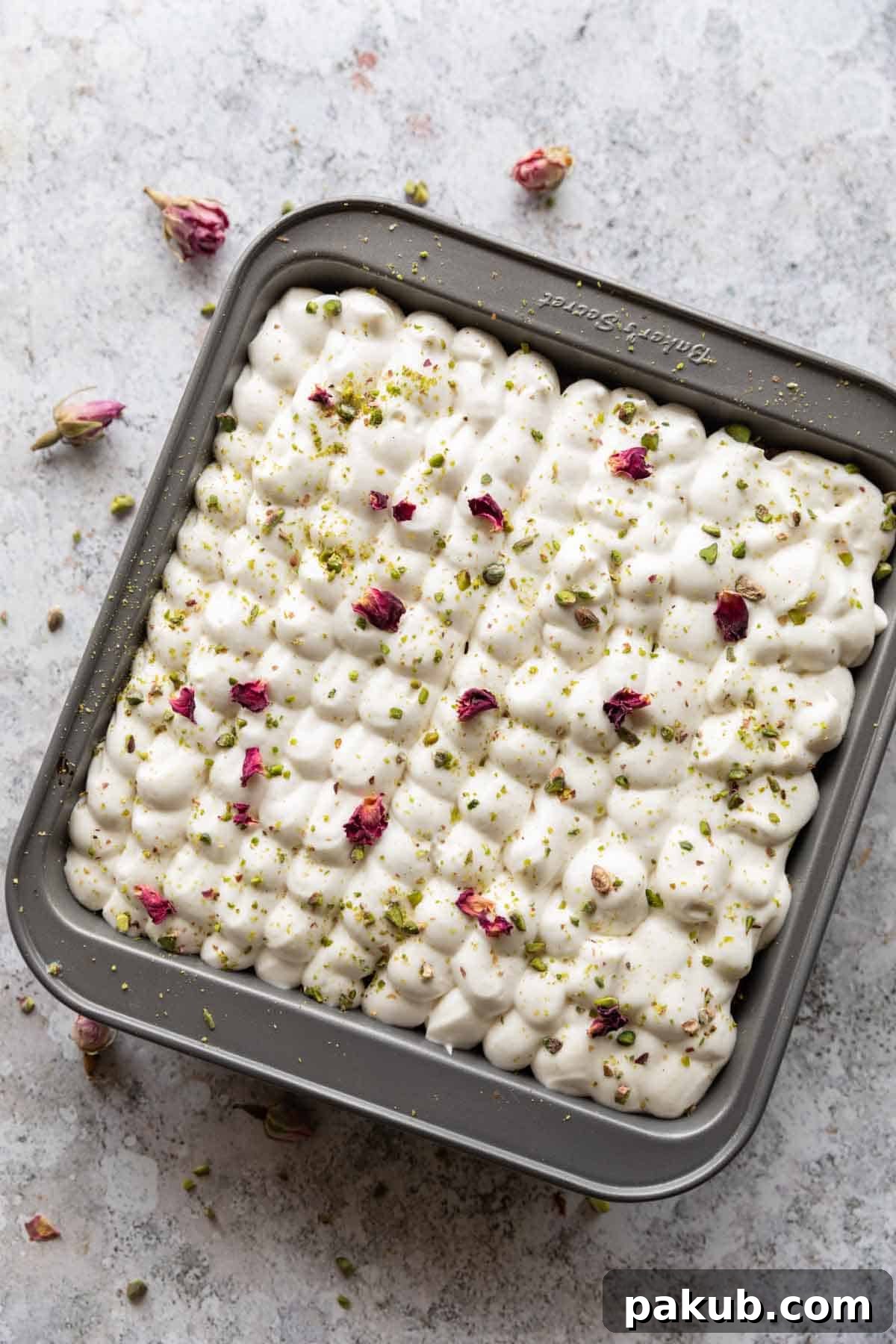 A second close-up shot of the rasmalai cake slice, highlighting its moist texture and rich garnishes.