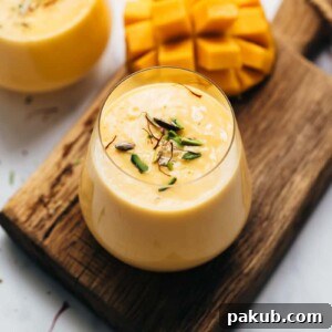 Two enticing glasses of thick, creamy mango lassi, ready to be enjoyed
