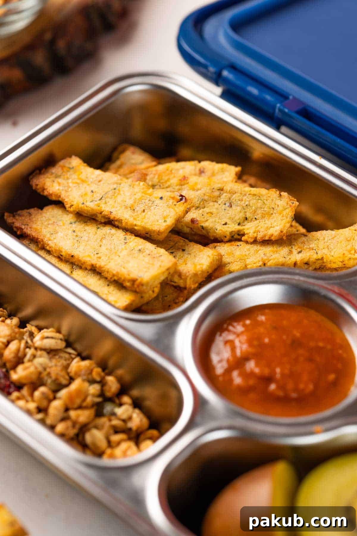 Crispy Sooji Fries 4 A tiffin box filled with crispy sooji fries, served alongside homemade tomato ketchup and a farsan mix, showcasing a healthy and delicious meal.