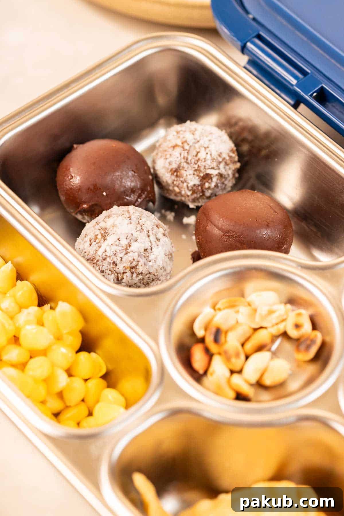 Naturally Sweetened Peanut Butter Power Balls 3 Peanut butter and oat energy balls with dates, neatly packed in a tiffin box for a convenient and healthy snack on the go.