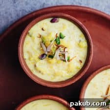 An inviting overhead shot of creamy Rice Kheer, gracefully served in traditional mud pots, evoking a sense of authentic Indian tradition.