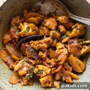 Aloo Gobi Masala served fresh from a traditional Indian kadhai or wok, ready to be enjoyed.