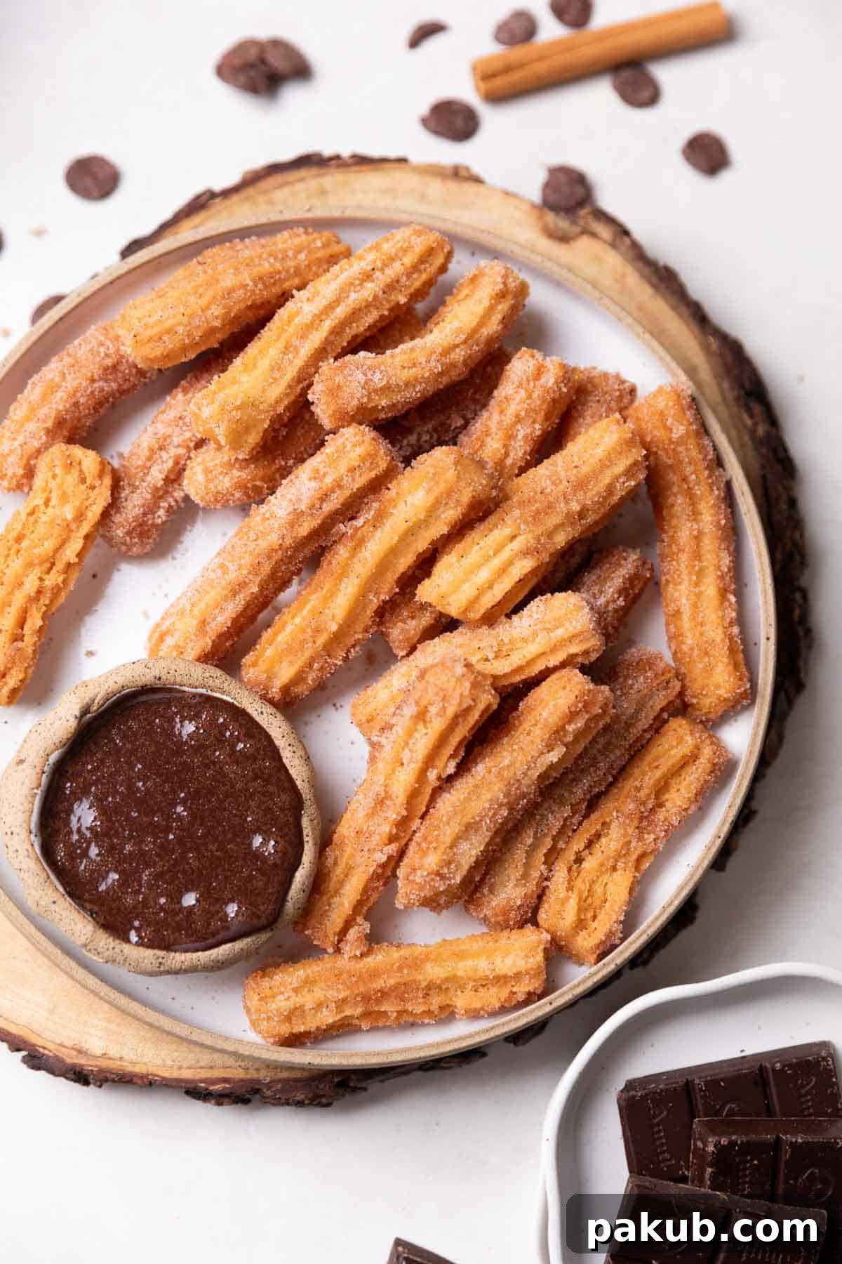 Plant-Based Churros 2 Crispy Eggless Churros served warm with a rich chocolate dipping sauce, garnished with cinnamon sugar.