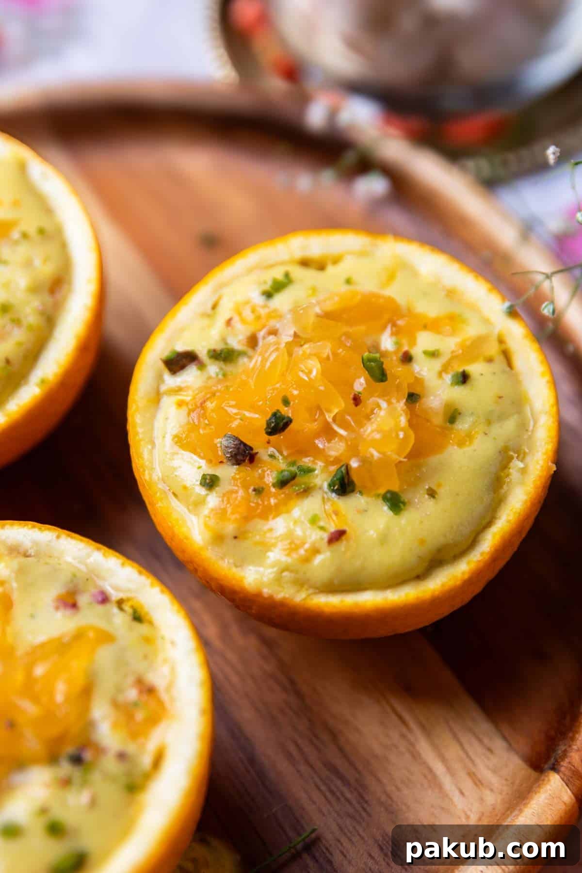 A mesmerizing close-up of the smooth, creamy orange makhana pudding, beautifully presented in its orange peel bowl.
