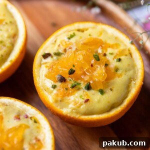 A close-up view of the orange makhana pudding elegantly served in orange peel bowls, highlighted by a subtle glow.