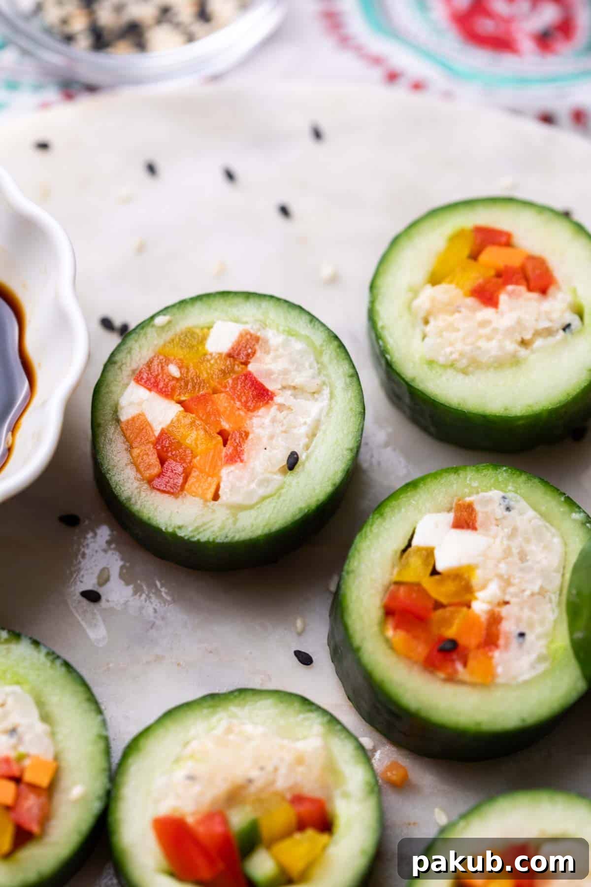 close up of cucumber sushi served with soy sauce