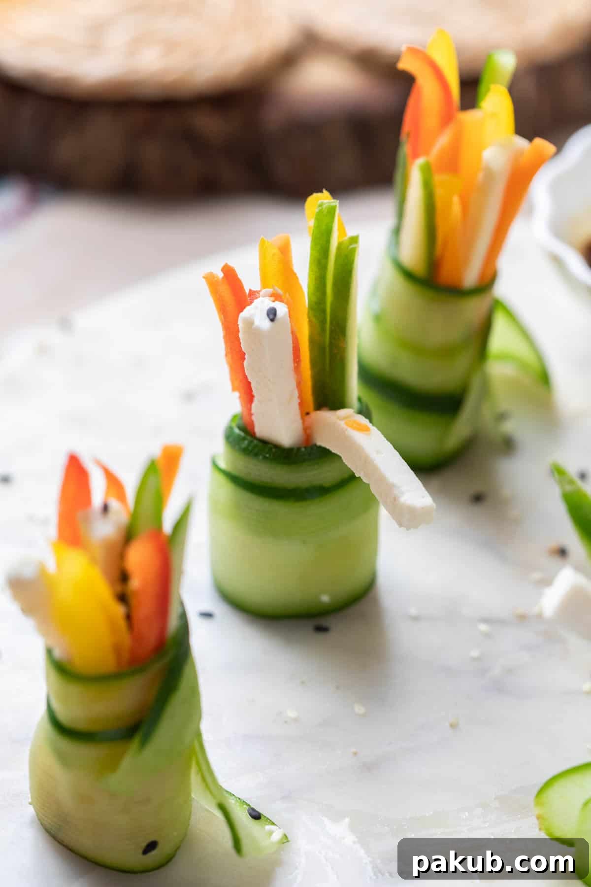 Crisp cucumber rolls served elegantly on a white platter, garnished with sesame seeds, ready to be enjoyed as a vibrant Diwali appetizer.