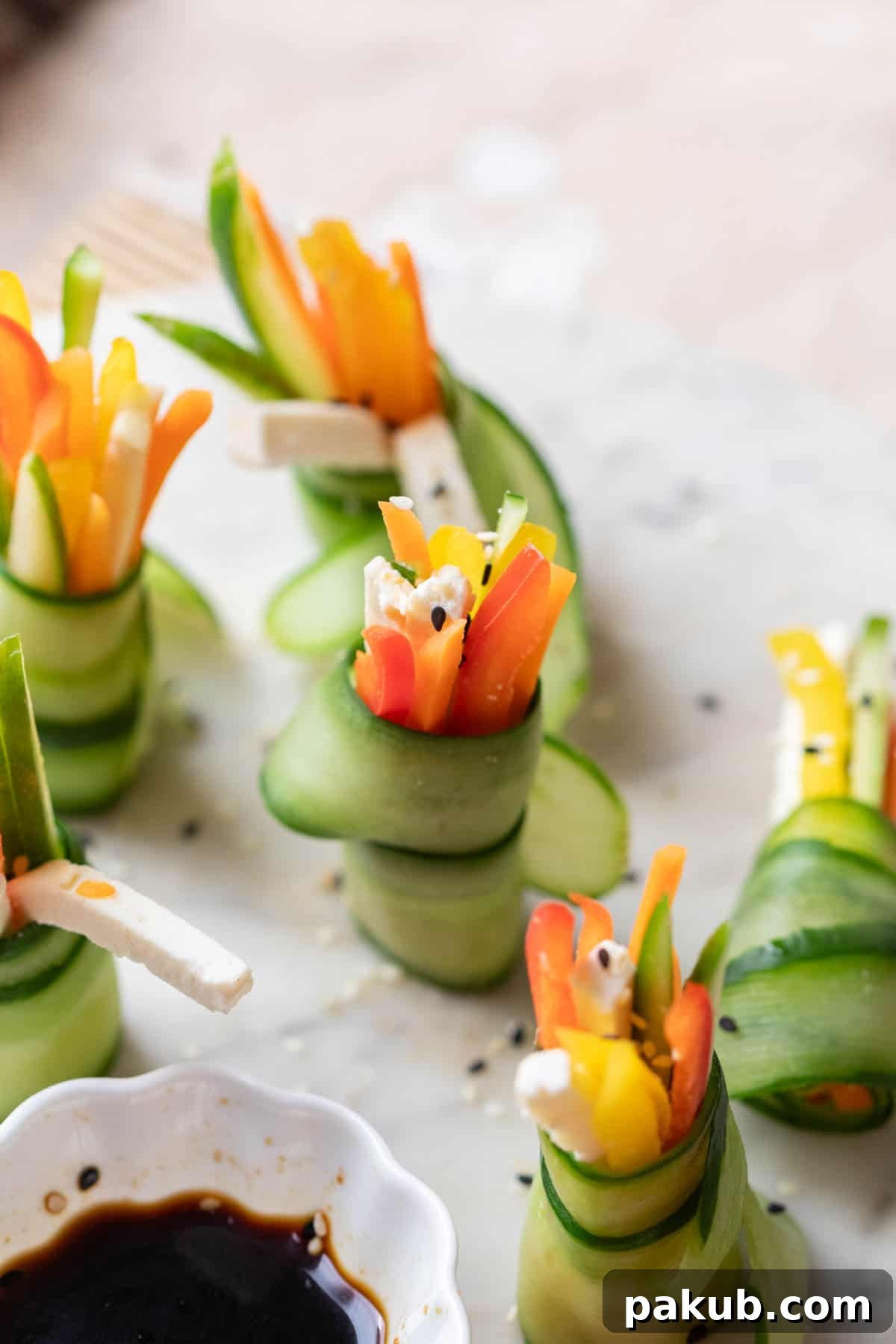 Close-up of freshly prepared cucumber rolls on a white serving dish, highlighting their vibrant colors and appealing texture, ready for a party.