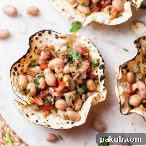 Edible papad bowls filled with peanut chaat, ready to serve on a white platter.