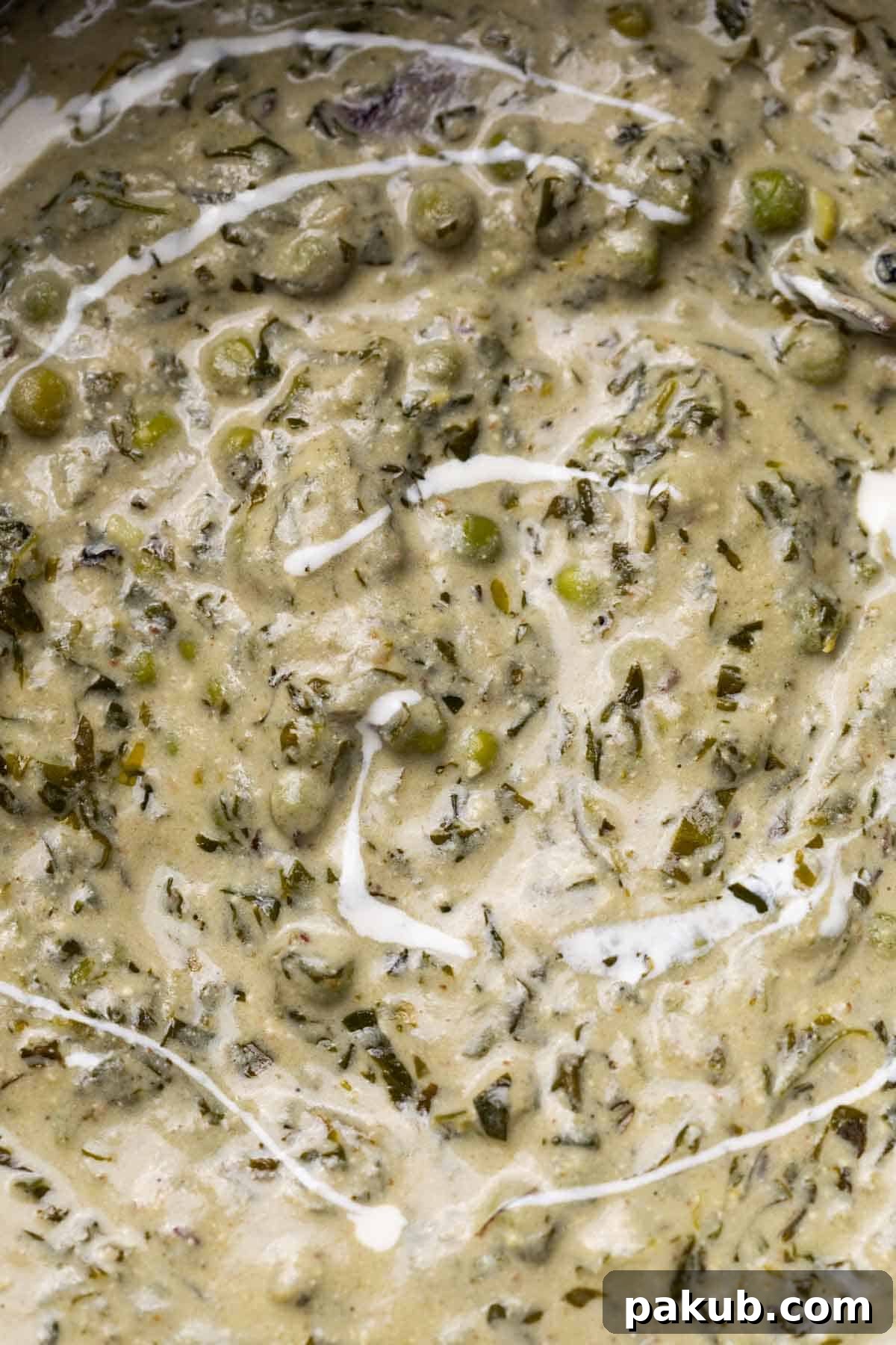 A close-up shot revealing the smooth and luxurious texture of Methi Matar Malai within a white serving bowl, showcasing its rich and inviting consistency.