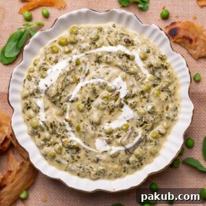 Methi Matar Malai served in a white bowl with lachha paratha, fenugreek leaves, and peas.