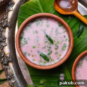 sol kadhi served in small earthen bowls with a spoon