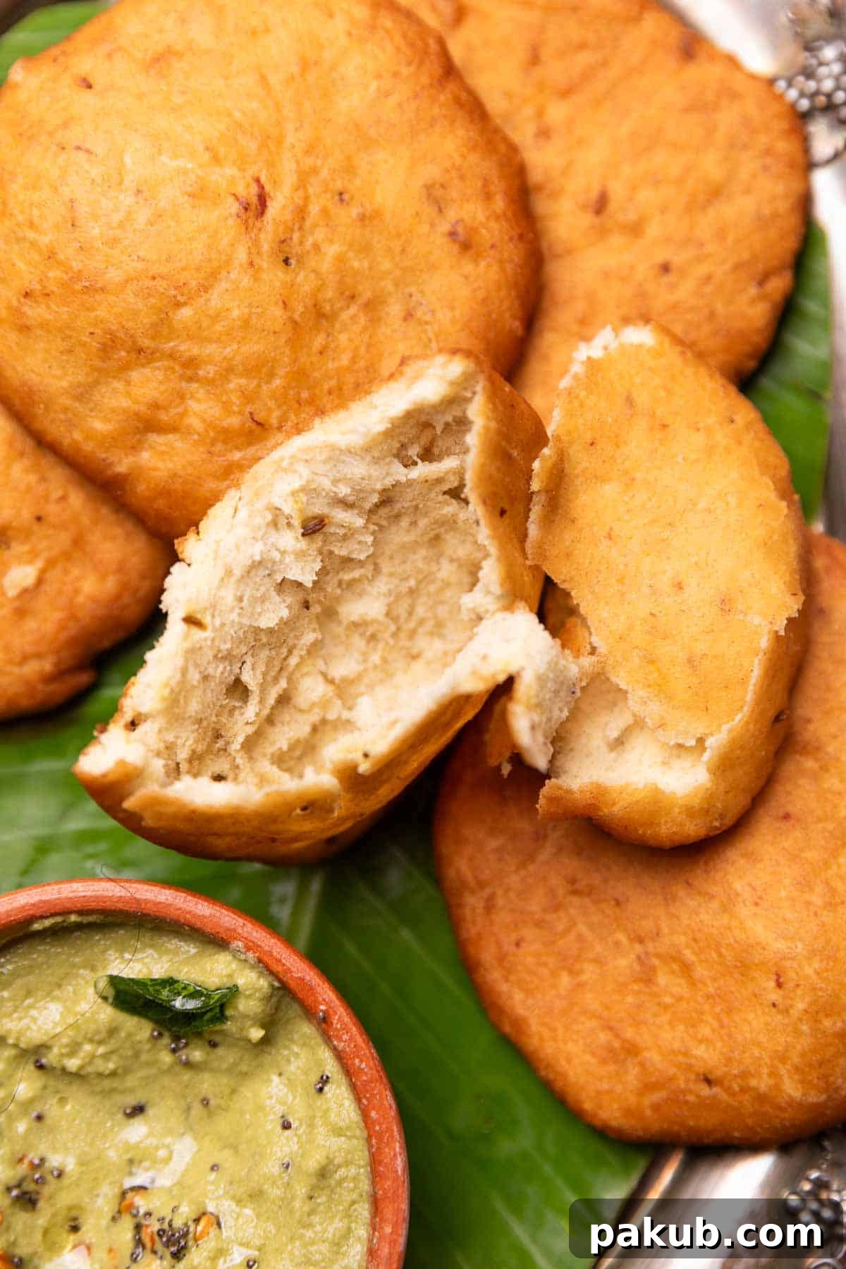 a close up image of mangalore bun broken in half to show the light and airy texture
