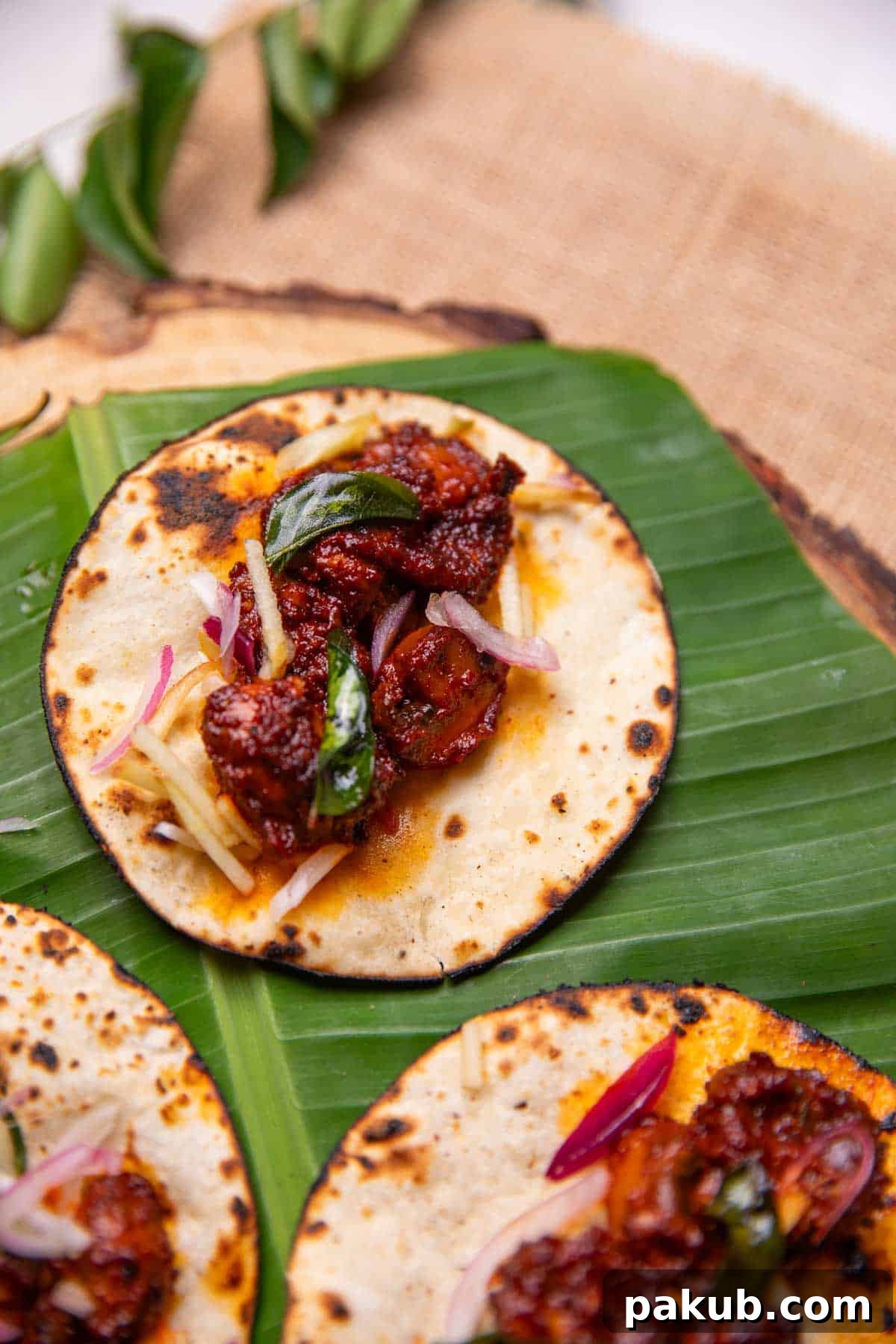 Beautifully arranged Mushroom Ghee Roast Tacos on a rustic serving plate, garnished with fresh herbs and fried curry leaves