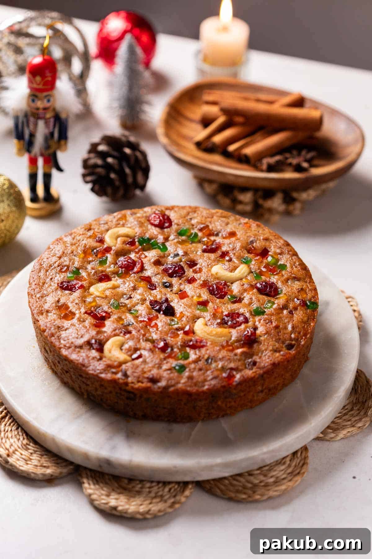 A beautifully baked whole eggless plum cake, garnished and ready for serving during the festive season.