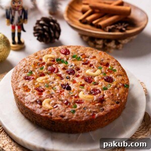 A delightful image of a freshly-baked whole eggless plum cake, perfect for holiday celebrations.