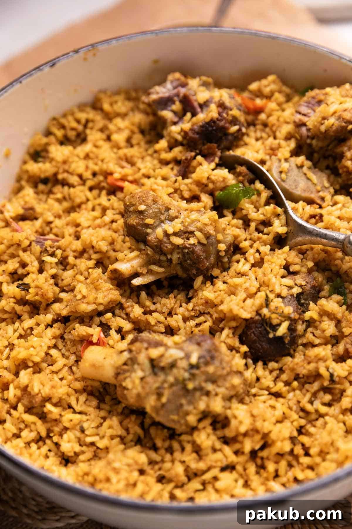 A close-up view of Dindigul mutton biryani, highlighting the fluffy rice grains, tender mutton pieces, and rich texture.