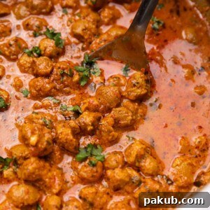 soya curry in a kadai with a ladle