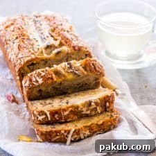 Quick Coconut Pistachio Banana Bread loaf sliced on a board.