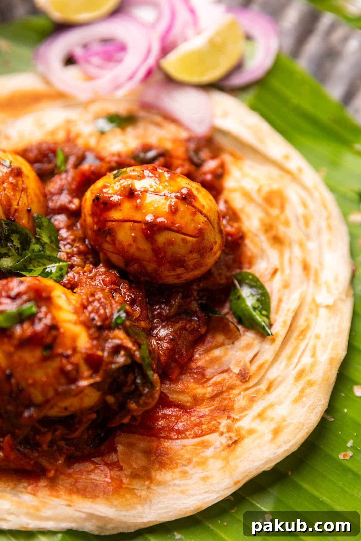 Authentic Kerala Egg Roast 3 Close up image of Kerala egg roast, highlighting the rich, glossy gravy coating the eggs, served with Malabar Parotta.