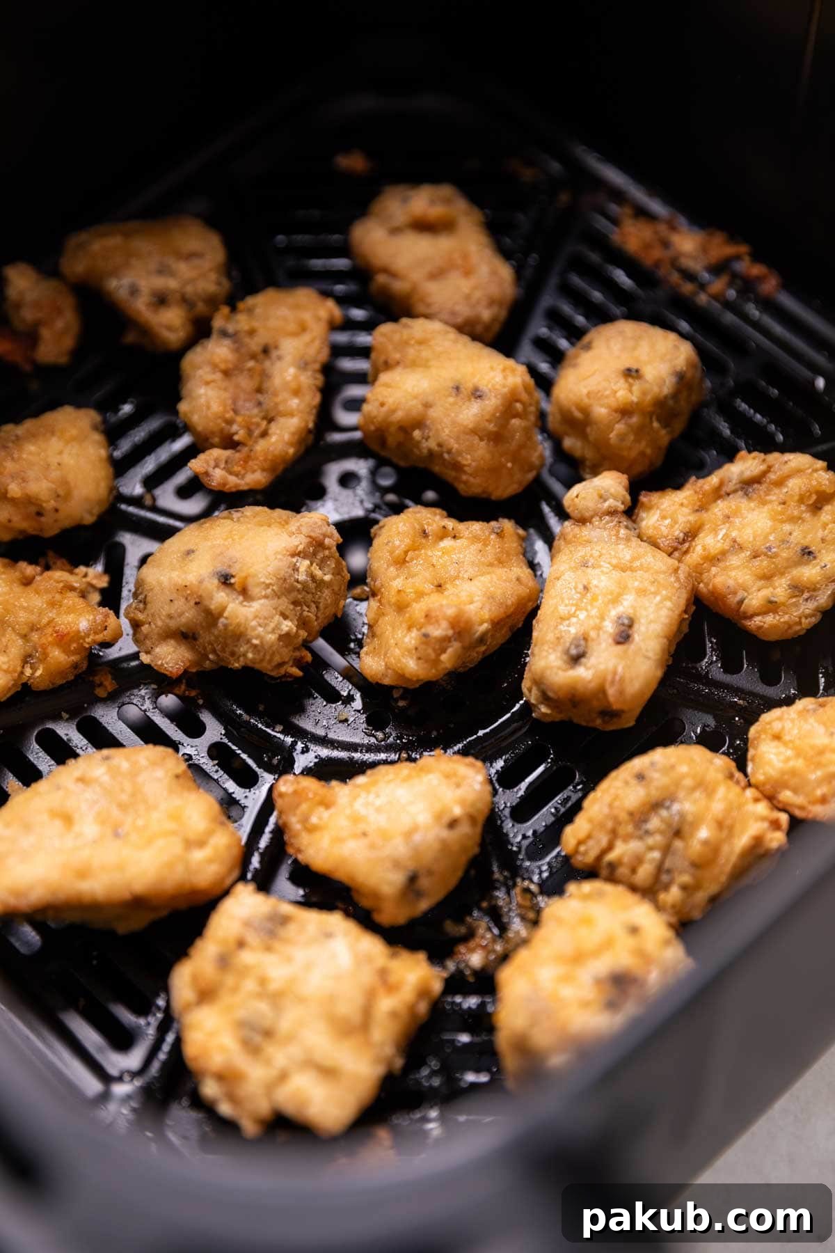 Crispy Air Fryer Salt and Pepper Chicken 3 Close up of a plate of Air Fryer Salt & Pepper Chicken garnished with green onions