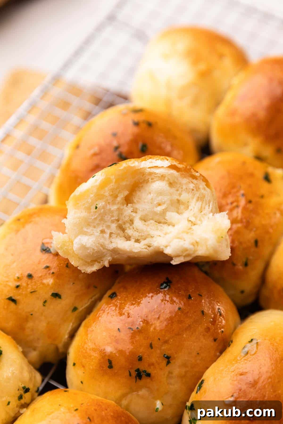 Effortless Air Fryer Dinner Rolls 2 An image of a freshly baked air fryer dinner roll broken in half to reveal its soft, fluffy, and airy interior, highlighting its perfect texture and readiness to be savored.