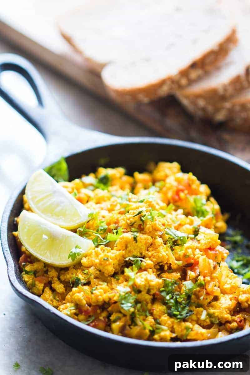 Close-up of Paneer Bhurji in a skillet, showcasing its texture and spices Super fast paneer bhurji or cottage cheese scramble with turmeric and spices for an easy to make Indian breakfast. One pan and ready in 15 minutes! Can be made vegan and dairy free by swapping paneer for tofu. Gluten free too!
