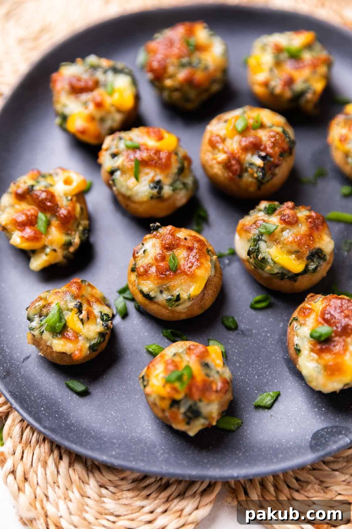 Perfect Air Fryer Stuffed Mushrooms 2 Crispy air fryer stuffed mushrooms served on a black plate, ready to be enjoyed.
