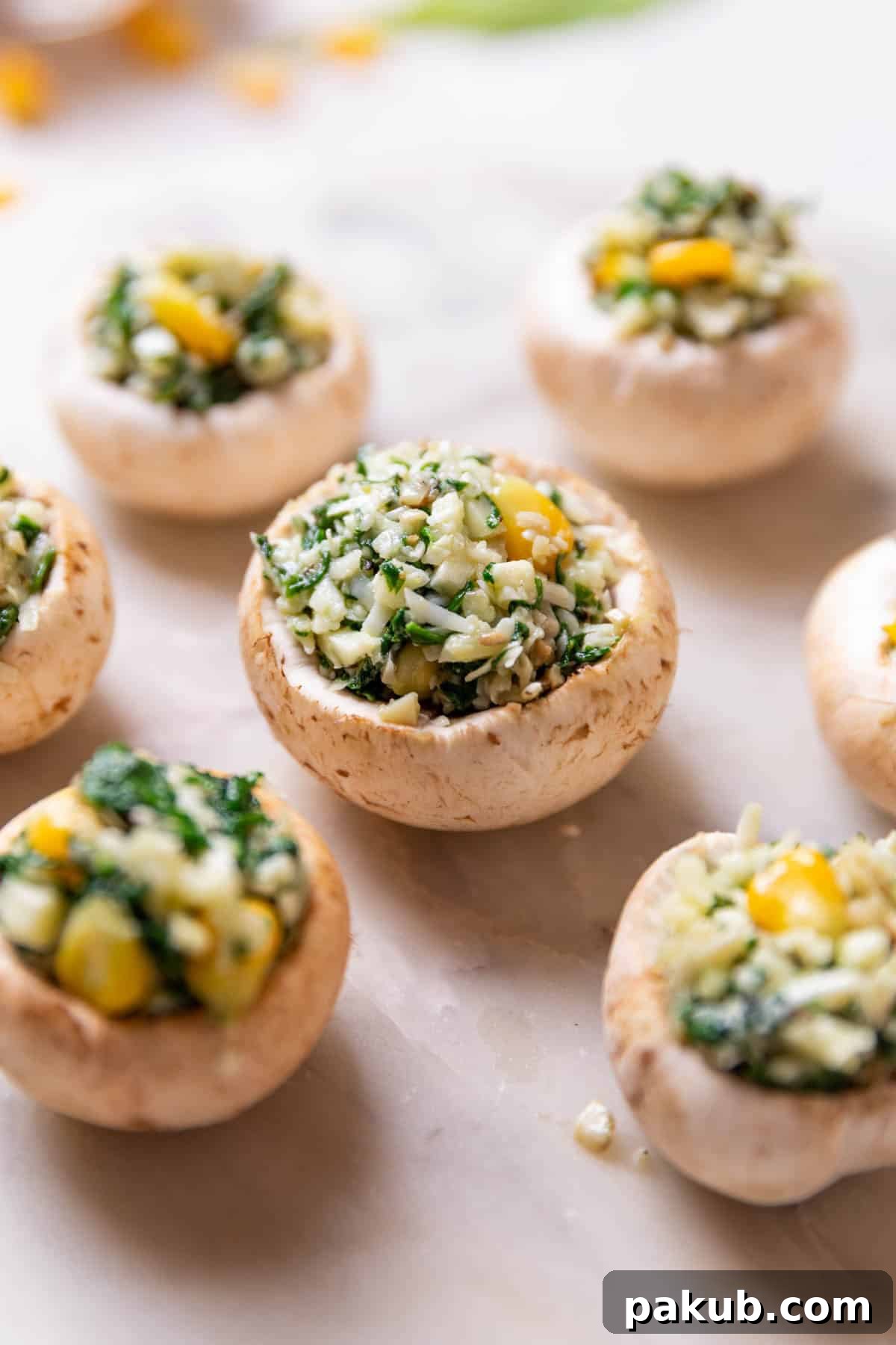 Perfect Air Fryer Stuffed Mushrooms 3 Mushrooms stuffed with a savory filling, arranged and ready to be air-fried to make delicious air fryer stuffed mushrooms.