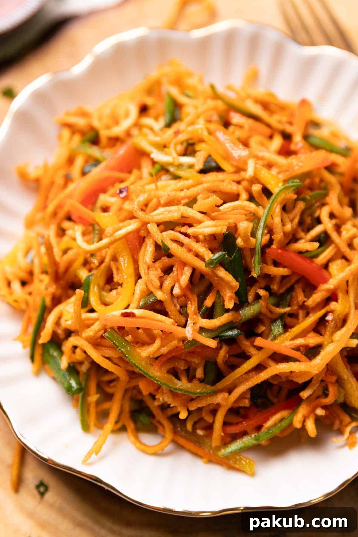 Indo-Chinese Street Crunch 4 A close-up view of Chinese Bhel, highlighting the crunchy fried noodles and colorful chopped vegetables coated in a glossy sauce.