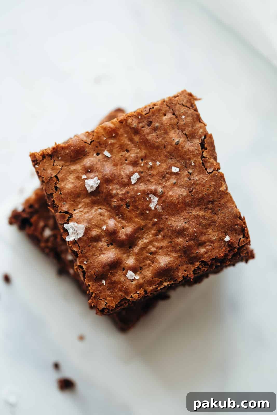 Perfectly cut Chickpea Flour Brownies topped with flaky sea salt