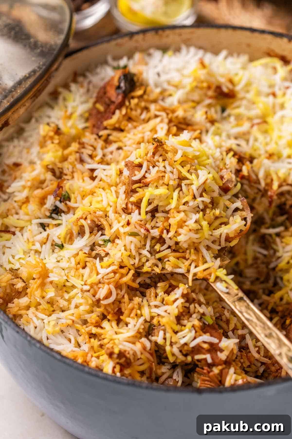 Aromatic Jackfruit Biryani 2 jackfruit biryani in a handi with ladle, garnished with mint leaves