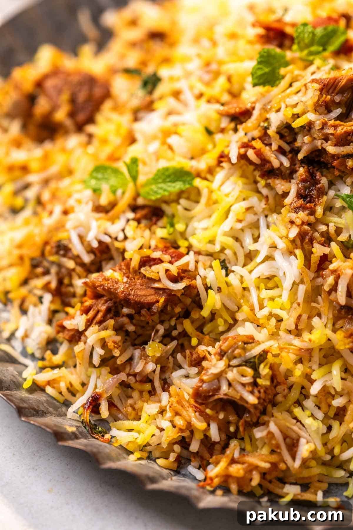 Aromatic Jackfruit Biryani 3 a close up image of jackfruit biryani garnished with mint leaves to show its fluffy texture and tender jackfruit chunks