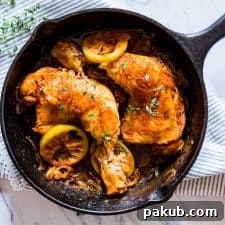 Golden Lemon Thyme Chicken Legs with Sweet Caramelized Onions 2 Caramelized Onion Thyme Lemon Chicken Legs in a black pan.