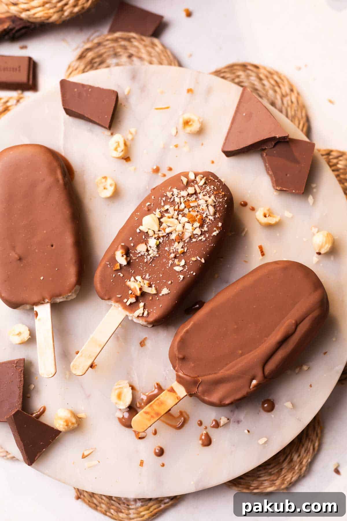 healthy chocobar ice creams garnished with chopped nuts and placed on a white platter