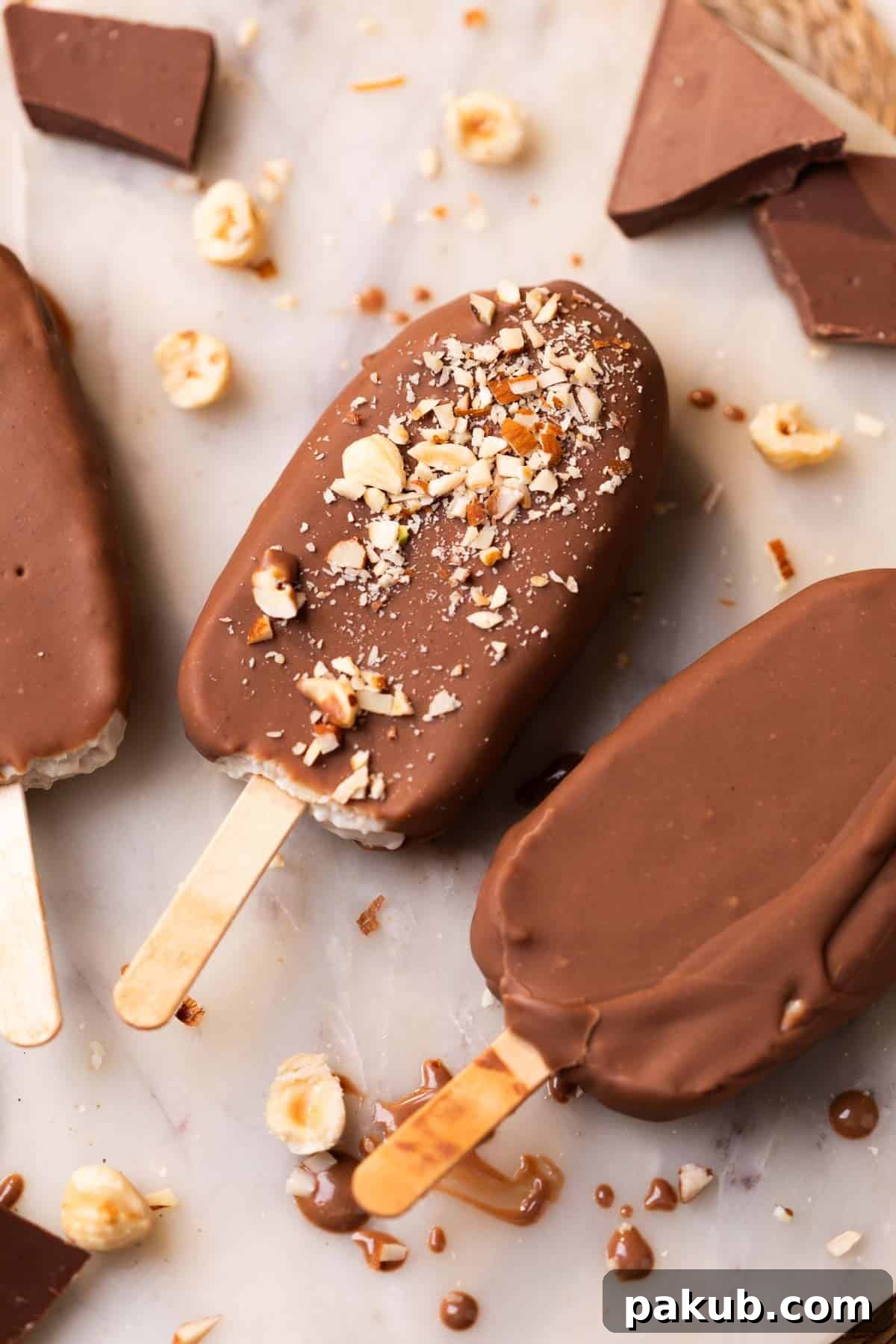 healthy chocobar ice creams garnished with chopped nuts and placed on a white platter