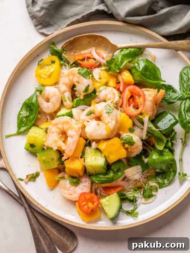 Beyond Sweet: Irresistible Savory Mango Recipes 5 A beautifully composed Thai Prawn Mango Salad, showcasing plump prawns, fresh mango, and crisp greens, creating a visually appealing and delicious meal.
