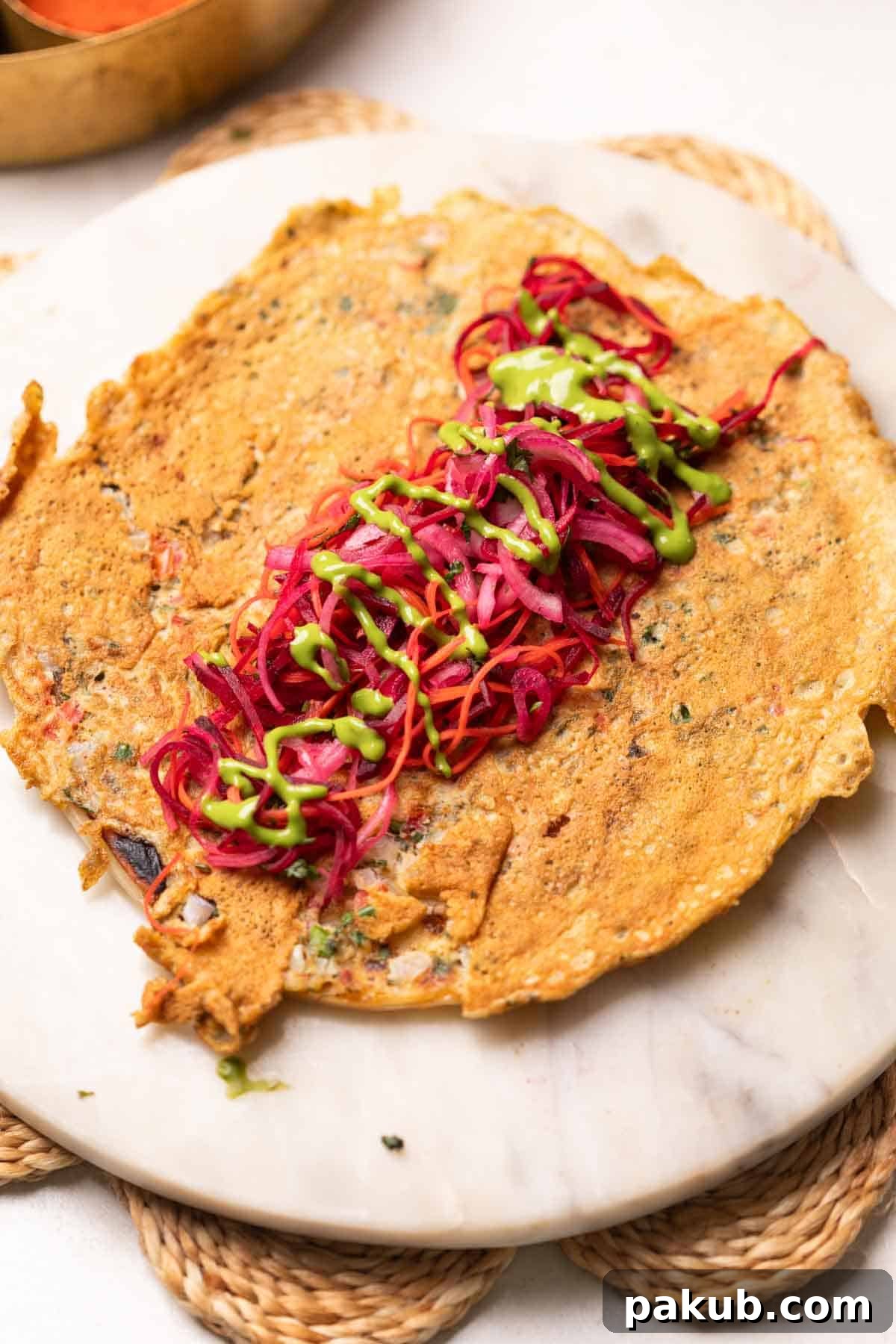 a flatlay image of anda paratha with filling in the middle
