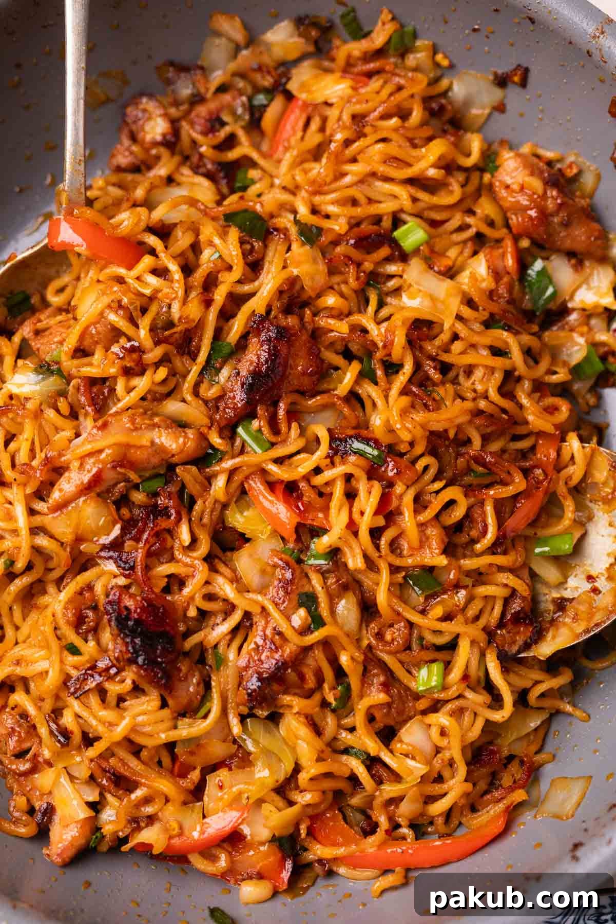 Freshly made chilli chicken noodles still in the pan