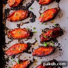 Korean Baked Gochujang Chicken Wings baked to perfection, garnished with sesame.