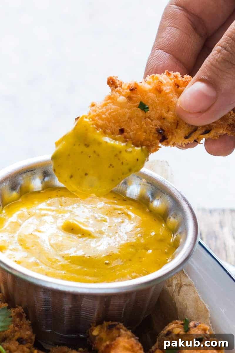 Baked Coconut Chicken Tenders with Mango Mustard Sauce Easy recipe for super crunchy baked coconut crusted chicken tenders which are going to be a favourite at every party with kids and adults alike! Gluten free too.
