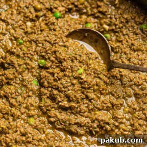 Green keema masala simmering in a copper kadai, ready to be served.
