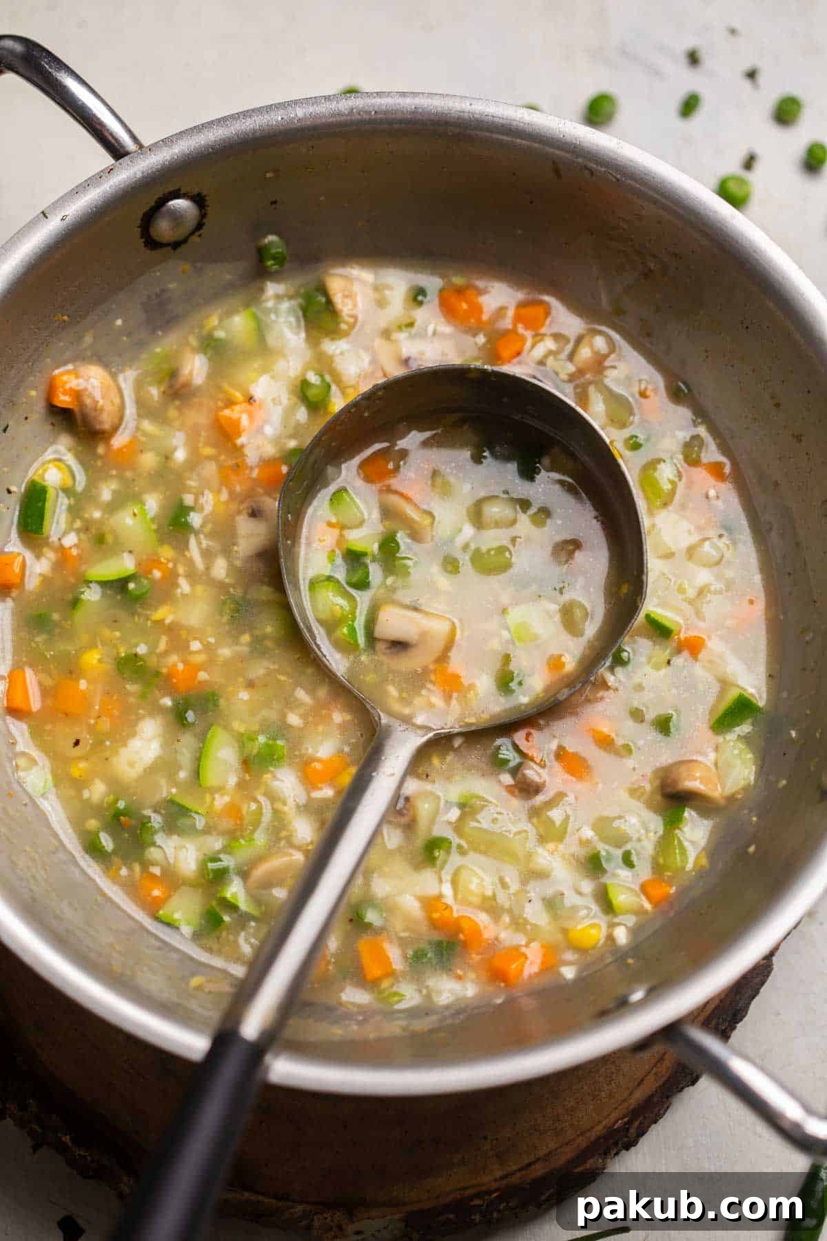Freshly cooked Eight Treasure Soup still in the kadai (wok) with a ladle, showcasing its vibrant colors and inviting texture, ready to be served.