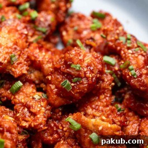 Close up of honey garlic chicken to show its crispy texture and glossy, sticky finish