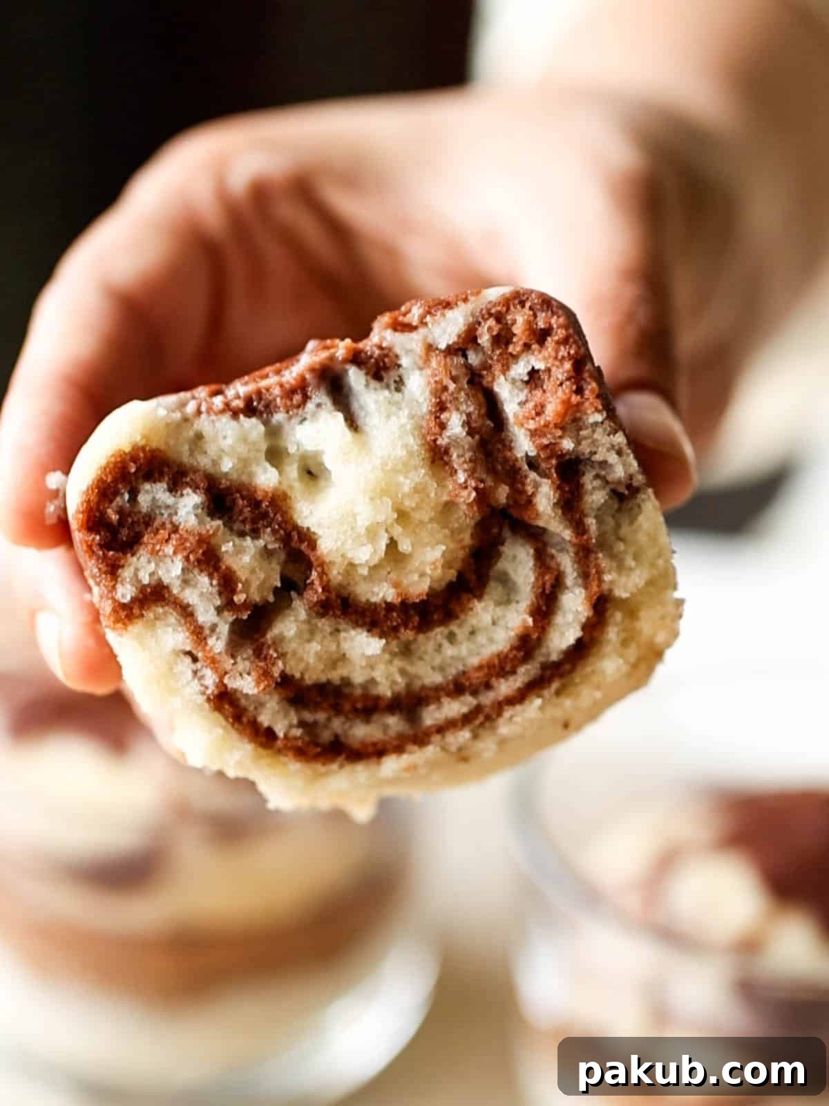 No-Fuss Eggless Marble Cakes No Oven No Microwave 3 A close-up view of an eggless marble cake, cut open to reveal its perfectly swirled vanilla and chocolate interior, highlighting its moist and soft texture.