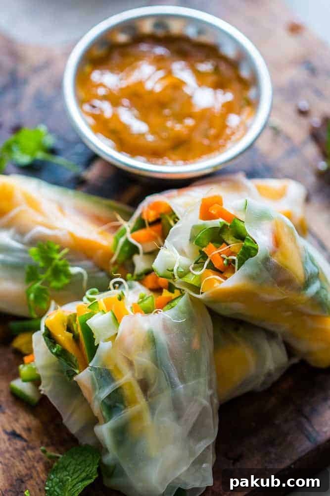 Close-up of freshly prepared Mango Bell Pepper Rice Paper Rolls, showcasing the vibrant colors of mangoes and bell peppers.